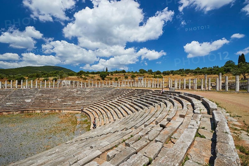 Ancient stadium with rows of seats and wild grass under a cloudy sky, archaeological site, Ancient Messene, capital of Messinia, Messini, Peloponnese, Greece, Europe