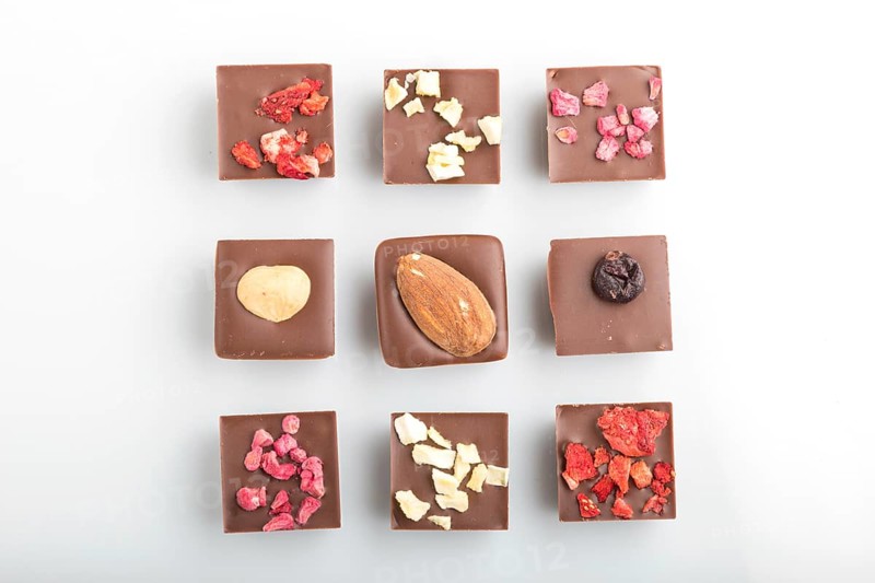 A pieces of homemade chocolate isolated on white background. top view, flat lay, close up