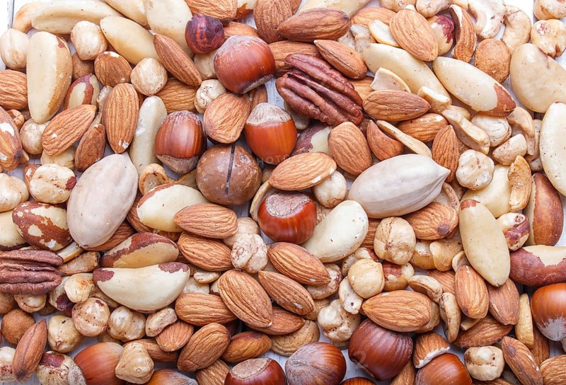 Background and texture made from different kinds of nuts. hazelnut, brazil nut, almond, pumpkin seeds, cashew. top view