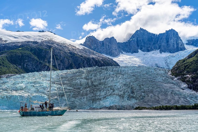 Sailing yacht between ice floes in Pia Bay in front of Pia Glacier, Alberto de Agostini National Park, Avenue of the Glaciers, Chilean Arctic, Patagonia, Chile, South America