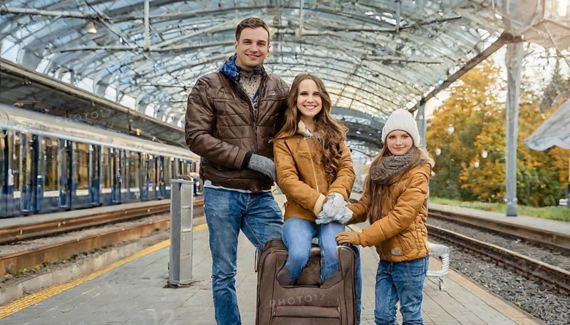 AI generated, A young family wants to travel and waits in the station for the train, 30, 35, years, blond, blonde, man, woman, knd, children, 10, 12, modern, modern, suitcase, handbag, winter jacket, white, sneakers, shoes, sexy, attractive, attractive, long-haired, transport, traffic, four people, family
