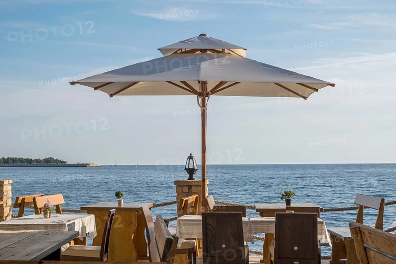 Tables in a restaurant by the sea, Umag, Istria, Croatia, Europe