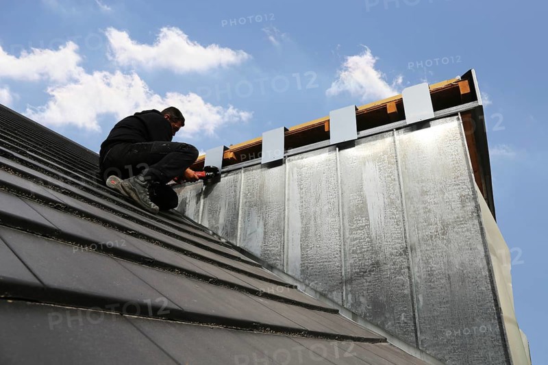 Roofer working on a new dormer window (model relased)
