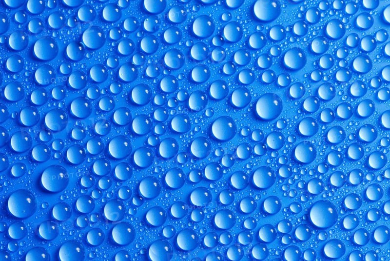 Many small water drops on a blue surface