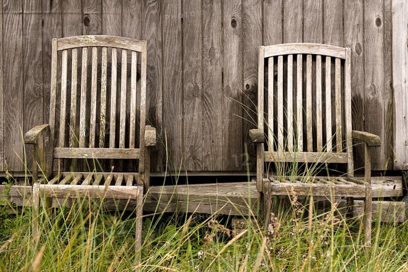 2 wooden chairs in front of a natural wooden wall of a fisherman's hut, Hvide Sande, Midtjylland region, Denmark, Europe
