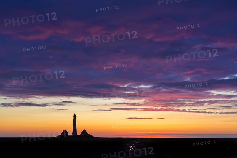 Lighthouse Westerheversand silhouetted against blue sunset sky, Westerhever, Wadden Sea National Park, North Frisia, Schleswig-Holstein, Germany, Europe