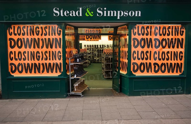 Stead and Simpson shoe shop closing down posters in window, Woodbridge, Suffolk, England, United Kingdom, Europe