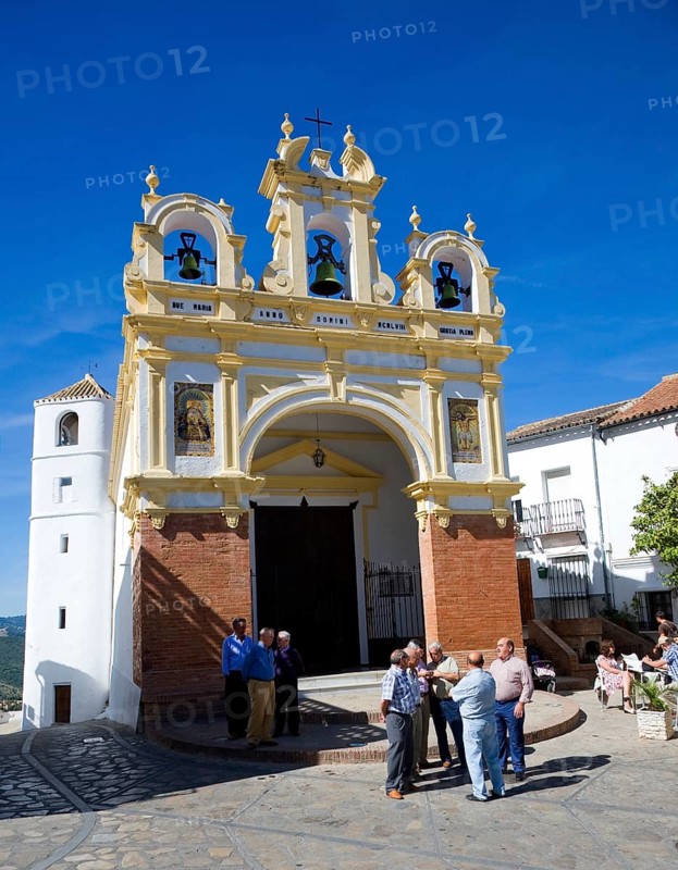 Men gather by the baroque church of San Juan at Zahara de la Sierra, Spain Sunday 13 October 2013 after the National Day holiday