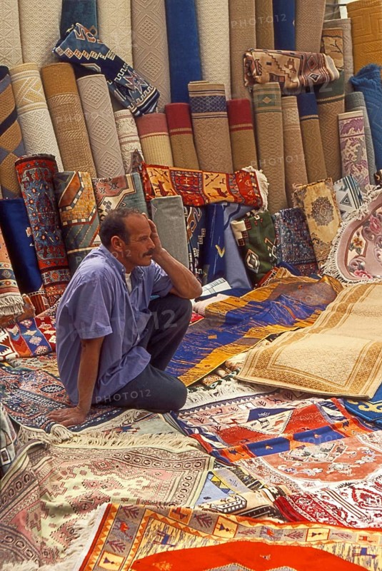Resting carpet seller at market in Torre del Mar, Andalusia, Spain, Southern Europe. Scanned thumbnail slide, Europe
