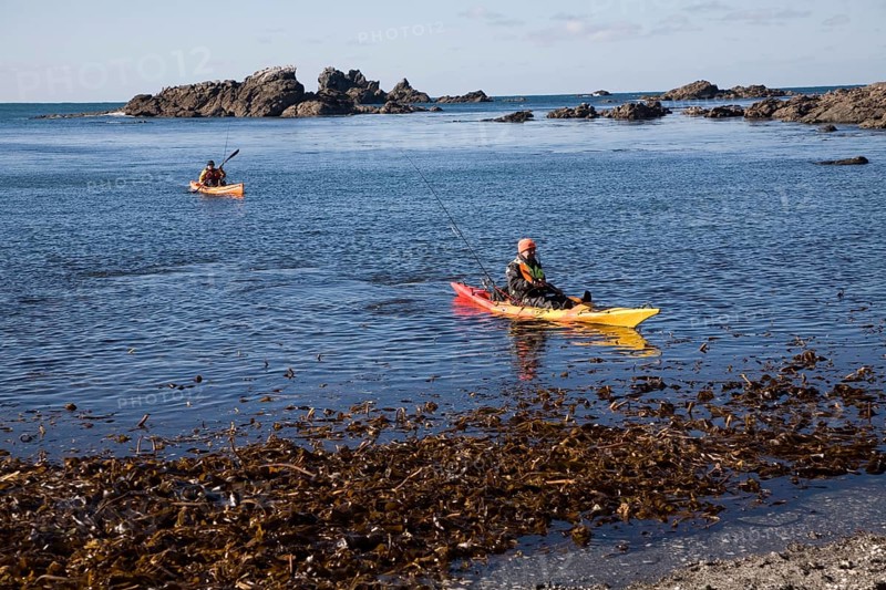 Two men fishing from kayak canoes off Lizard Point, Cornwall, England, United Kingdom, Europe