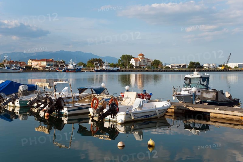 Motorboats are moored at a small jetty in a quiet harbour with a mountain panorama in the background, harbour and view of Porto Lagos, Xanthi, Eastern Macedonia and Thrace, Greece, Europe