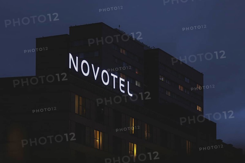 The Novotel hotel chain sign stands out in front of a block of flats in Berlin, 20/02/2024