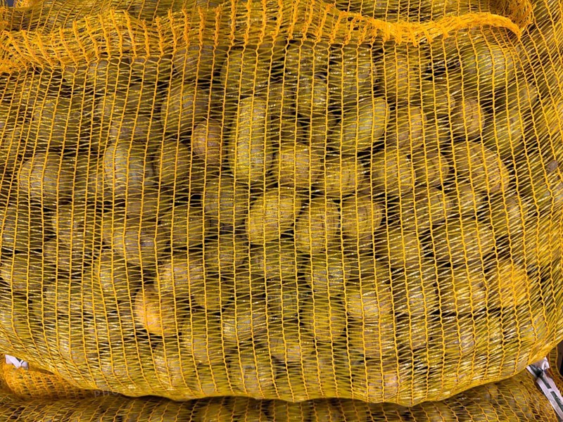 Display of variety of small table potatoes in nylon bag made of plastic Plastic packaging for food in grocery shop grocery store food retailer supermarket, Germany, Europe