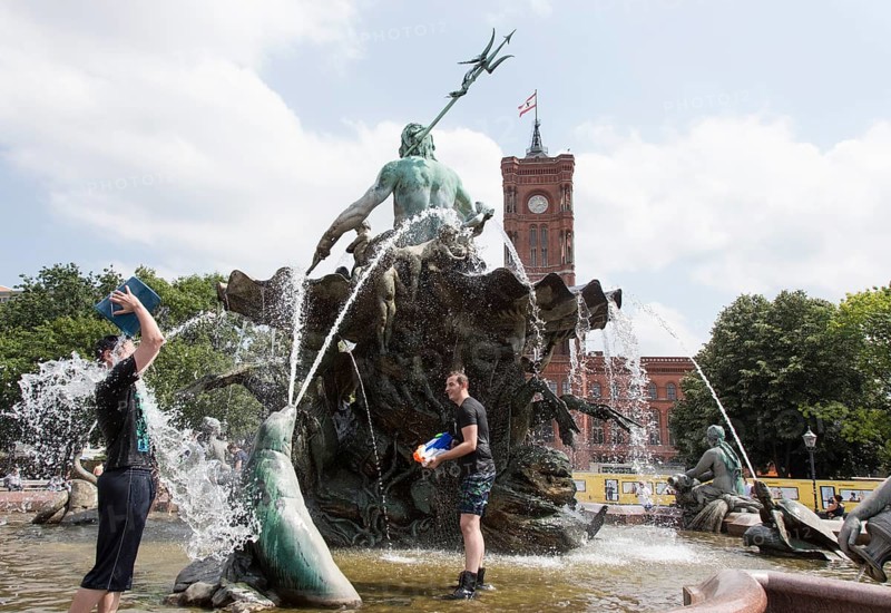 Water-hungry participants of this year's water fight at Berlin's Neptune Fountain cool off in summer temperatures on 17 June 2018. Buckets and large water pistols are ideal helpers for getting each other wet
