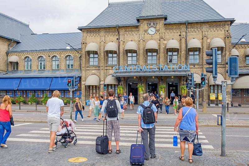 People at a pedestrian crossing on their way to the railway station to travel, Gothenburg, Sweden, Europe