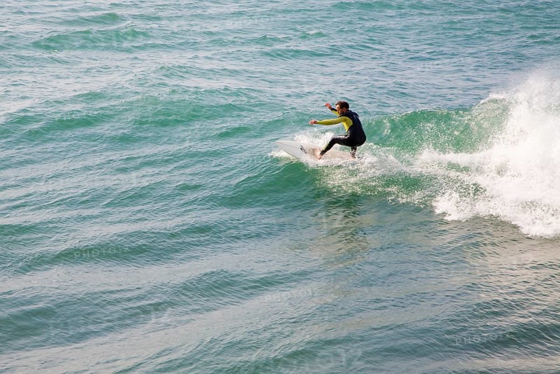 Young man wearing wet-suit surfing in Cornwall, England, United Kingdom, Europe