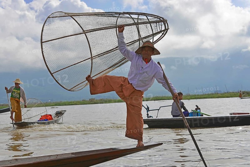 Intha fisherman, local man fishing with traditional conical fishing net, Inle Lake, Burma, Myanmar, Asia