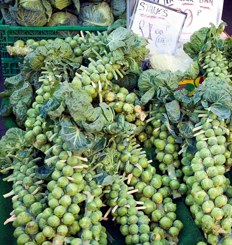 Stalks brussel sprouts on sale market stall priced Â£1.00