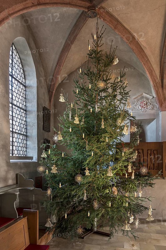 Christmas tree decorated with straw stars in St Egidienkirche, Beerbach, Middle Franconia, Bavaria, Germany, Europe