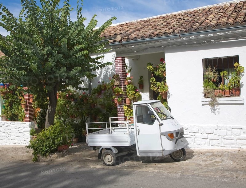 Small three wheeled truck vehicle outside village house Grazalema, Spain, Europe