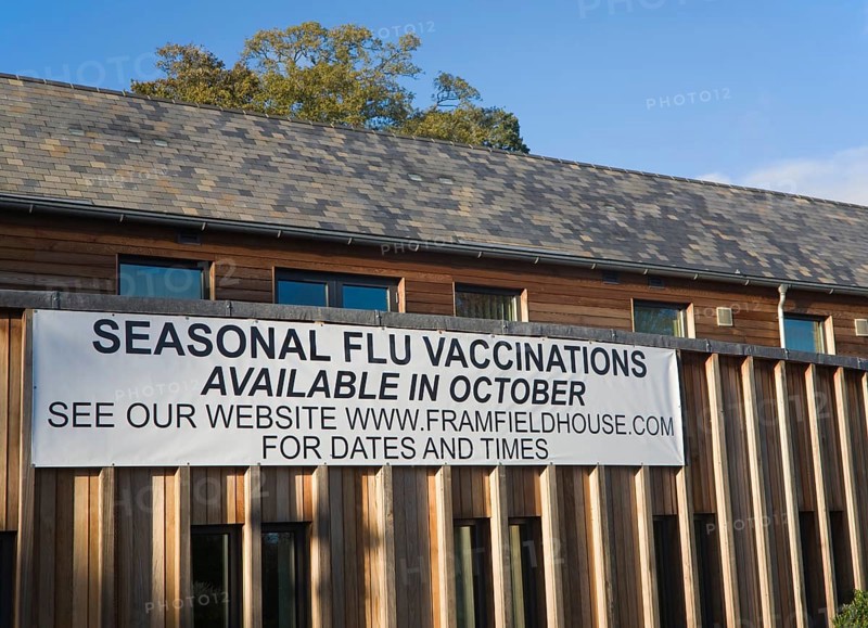Seasonal flu vaccinations available poster sign on Framfield health centre, Woodbridge, Suffolk, England, United Kingdom, Europe