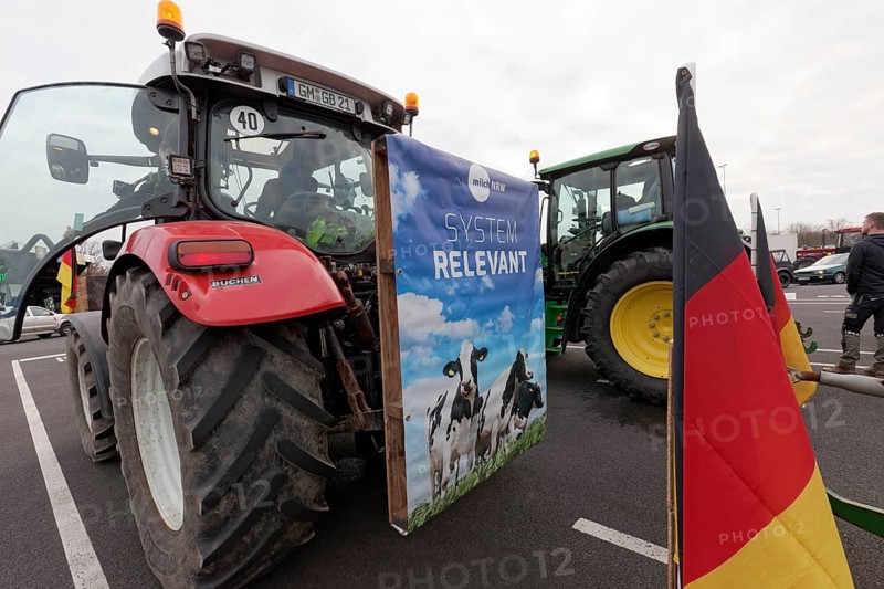 Poster with dairy cows and writing Systemrelevant on a tractor, farmer protests, demonstration against policies of the traffic light government, abolition of agricultural diesel subsidies, Duesseldorf, North Rhine-Westphalia, Germany, Europe
