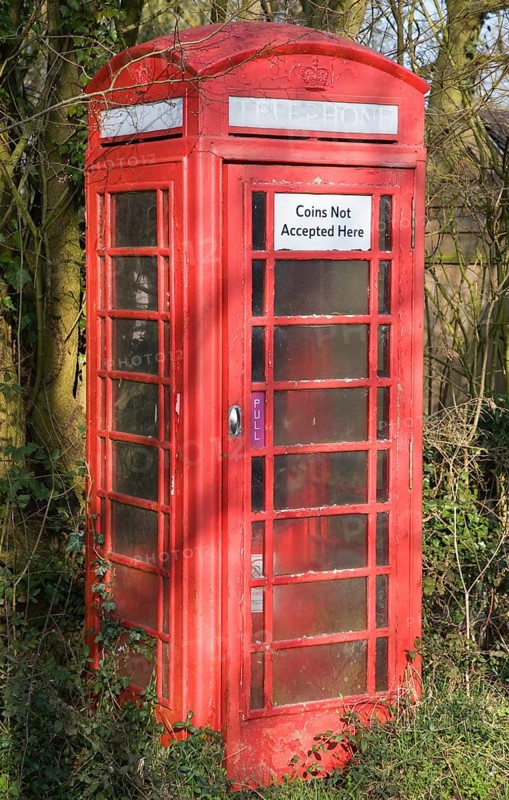 'Coins Not Accepted Here' sign on rural red telephone box, Suffolk, England, United Kingdom, Europe