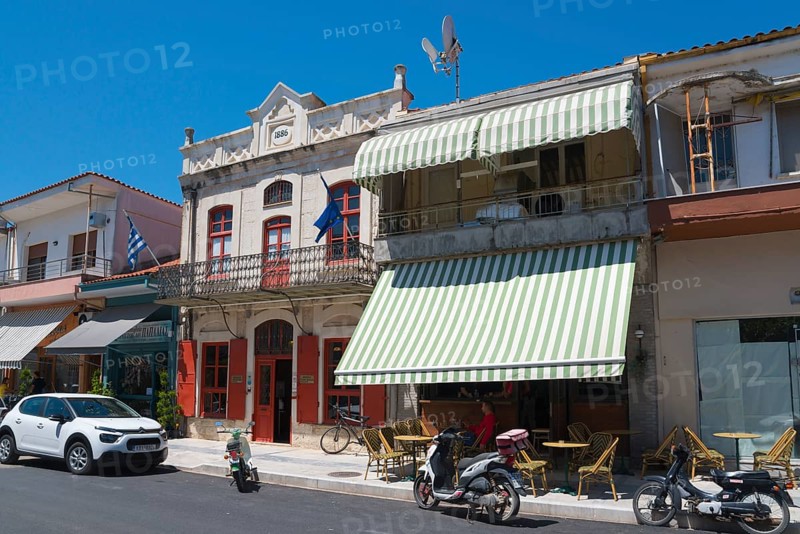 Traditional buildings on a sunny street with parked cars and motorbikes, Museum of Silk Art, Soufli, Eastern Macedonia and Thrace, Greece, Europe