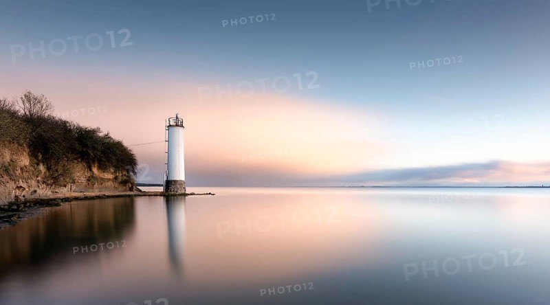 The Maltzien lighthouse stands at the foot of a small cliff at the southern tip of the Zudar peninsula on the island of Ruegen