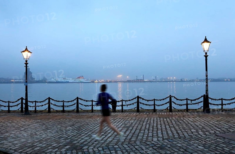 A woman jogs in the morning near the Royal Albert Dock in Liverpool, 01/03/2019