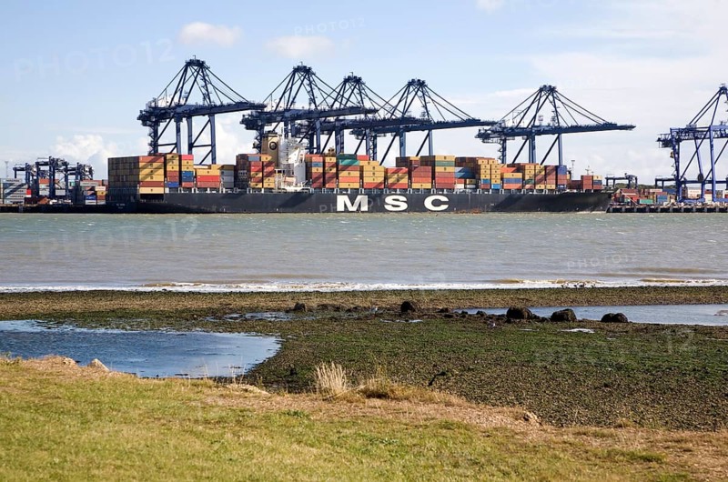 Cranes and container ships at Trimley Docks part of the Port of Felixstowe, Britain's busiest container port, from Shotley, Suffolk, England, United Kingdom, Europe