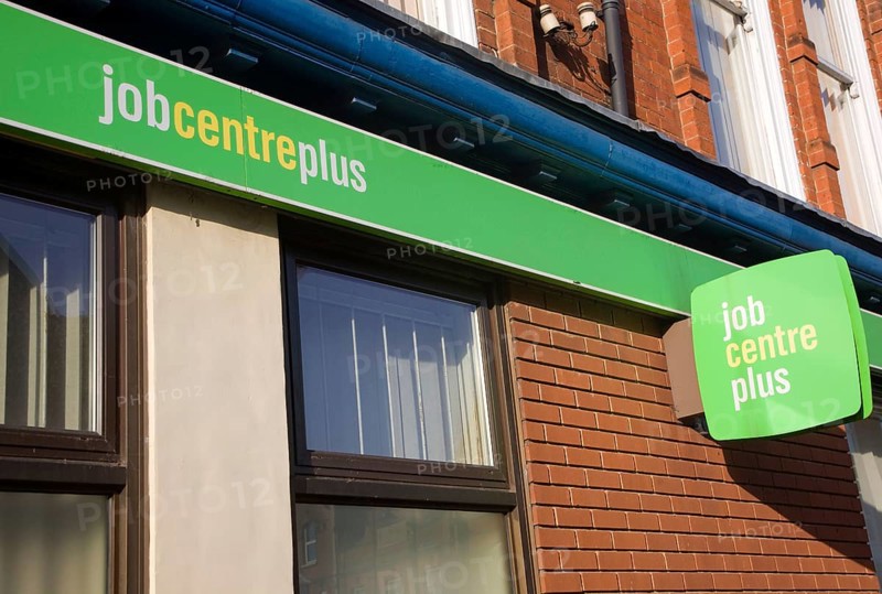 Close up of Job Centre Plus green signs on wall, England, UK
