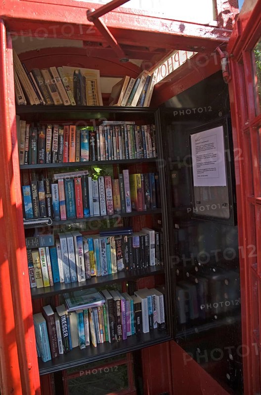 Old red telephone box used for book exchange, Suffolk, England, United Kingdom, Europe