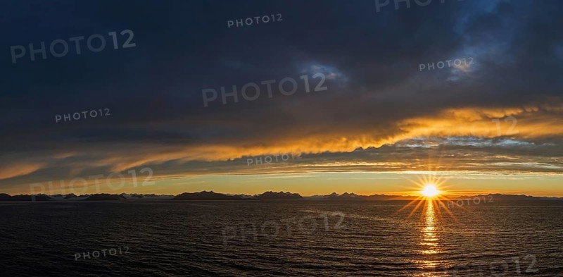 Sun setting on a rainy evening over Isfjorden, Isfjord in summer at sunset, Spitsbergen, Svalbard, Norway, Europe