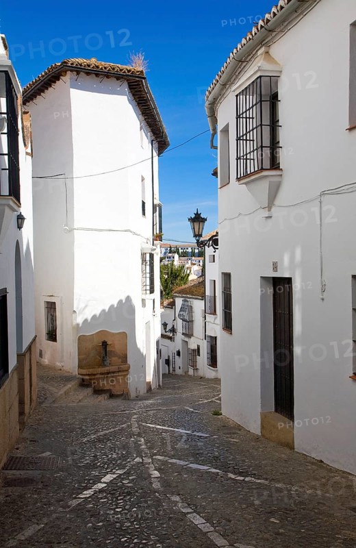 Historic street cobbled street architecture in old city Ronda, Spain, Europe
