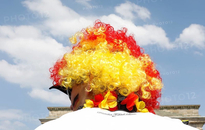 Football fan wears a wig with the colours of the German flag for the World Cup opening match between Germany and Mexico in the fan mile at the Brandenburg Gate in Berlin, 17.06.2018