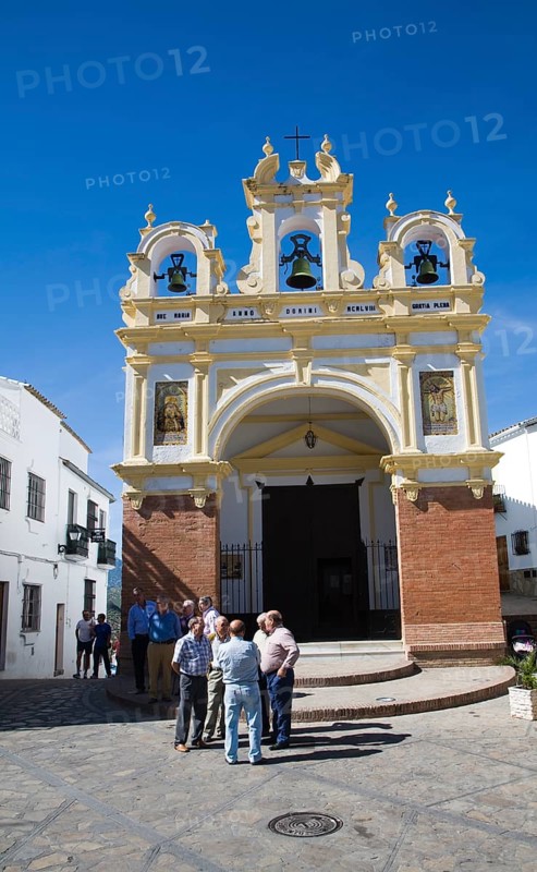 Men gather by the baroque church of San Juan at Zahara de la Sierra, Spain Sunday 13 October 2013 after the National Day holiday