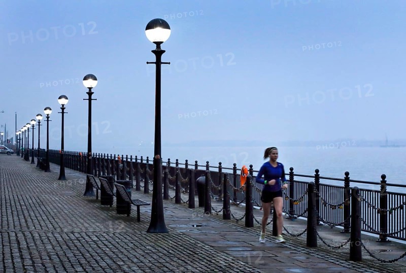 A woman jogs in the morning near the Royal Albert Dock, Liverpool, 01/03/2019