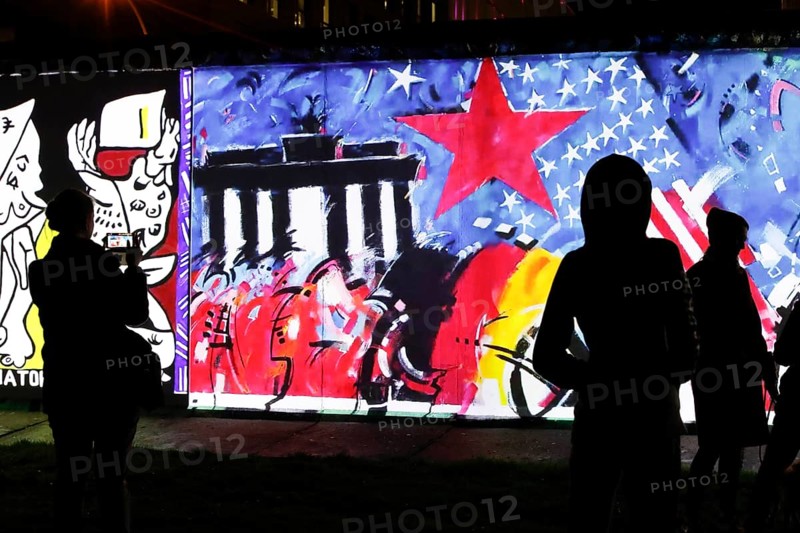 On the 30th anniversary of the fall of the Wall, 3D video projections of historical images and videos commemorate the events of the Peaceful Revolution and the opening of the Wall at original locations, such as here at the East Side Gallery, Berlin, 6 November 2019