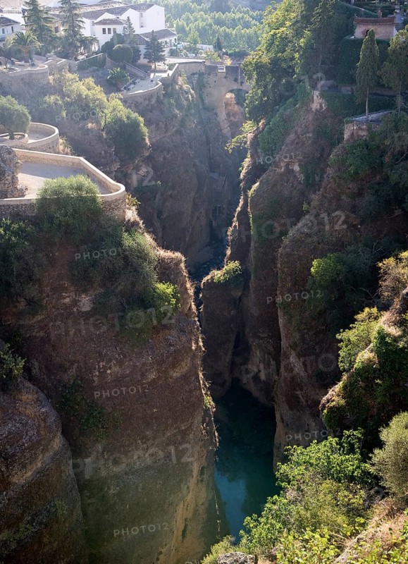 El Tajo canyon of the Rio Guadalevin river with white buildings perched on the cliff top, Ronda, Spain, Europe