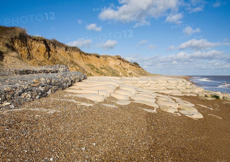 Coastal defences normally covered by shingle exposed by winter storms at Thorpeness, Suffolk, England in November 2013