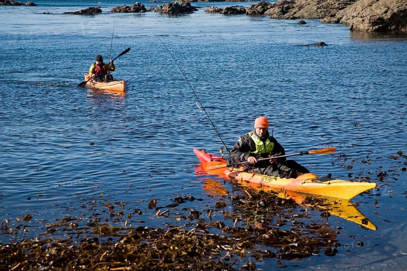 Two men fishing from kayak canoes off Lizard Point, Cornwall, England, United Kingdom, Europe