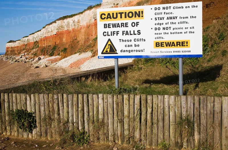 Caution beware of cliff falls sign at Hunstanton, Norfolk, England, United Kingdom, Europe
