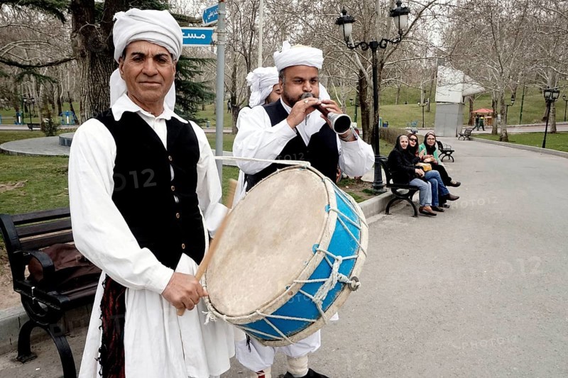 Musicians in traditional dress play music in a park in Tehran, Iran, woman, 14.03.2019, Asia