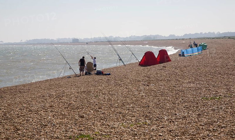 People sea fishing from beach, Hollesley Bay, Shingle Street, Suffolk, England, United Kingdom, Europe