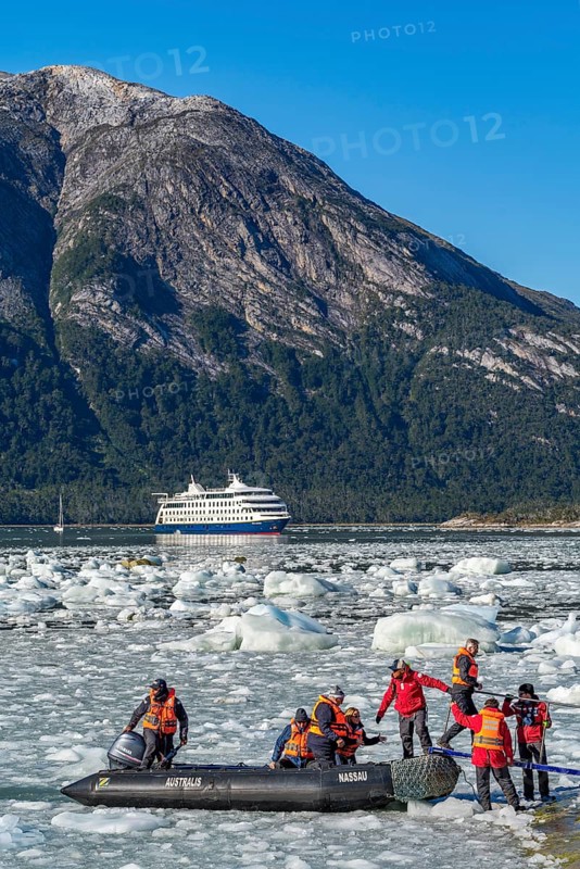 Passengers of the cruise ship Stella Australis land in a rubber dinghy between ice floes on the Pia Glacier, Alberto de Agostini National Park, Avenue of Glaciers, Chilean Arctic, Patagonia, Chile, South America