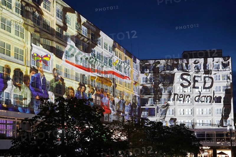 To mark the 30th anniversary of the fall of the Wall, 3D video projections of historical images and videos commemorate the events of the Peaceful Revolution and the opening of the Wall at original locations, such as here at Berlin's Alexanderplatz, 6 November 2019