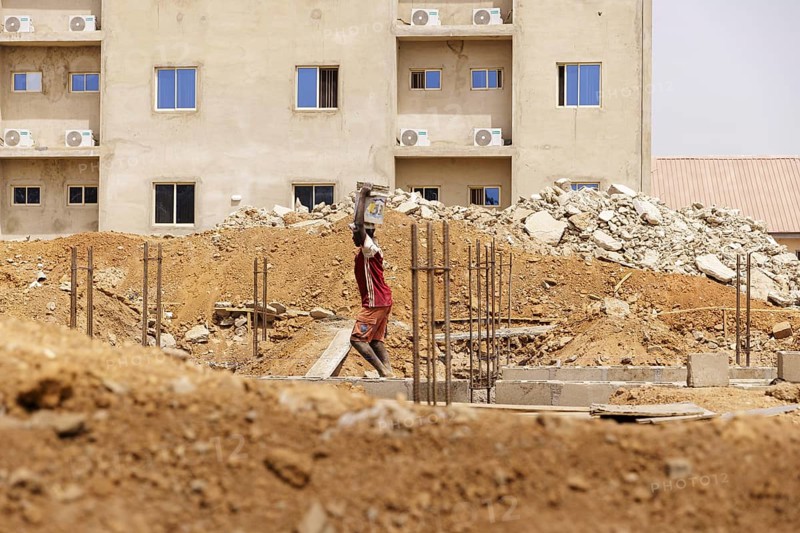 Young men working on a construction site in Nigeria, 06.02.2024