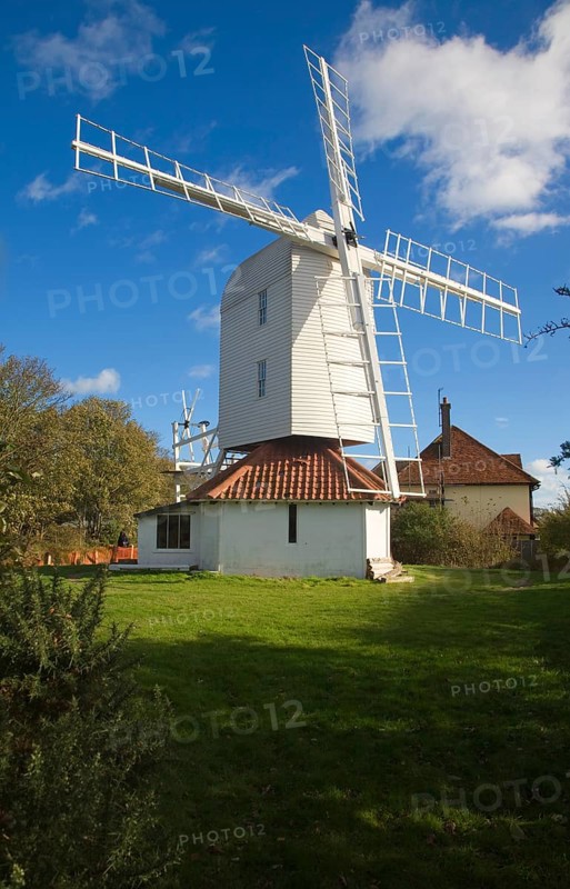 Thorpeness Windmill, Suffolk, England is a post mill built 1803 moved from Aldringham in 1923. It pumped water to the House in the Clouds seen in the background