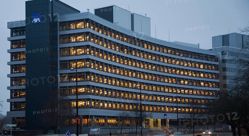 AXA insurance office illuminated by electric lights in winter afternoon, Ipswich, Suffolk, England, United Kingdom, Europe